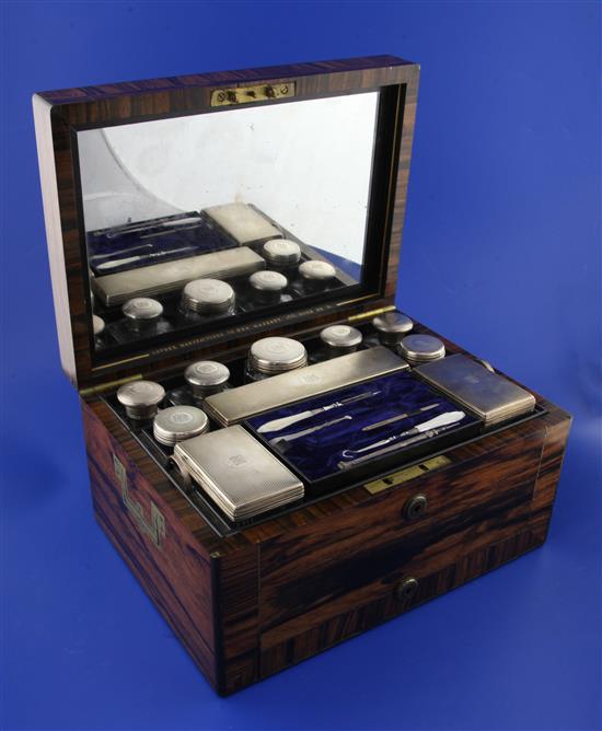 A Victorian brass inlaid rosewood travelling toilet box by Asprey containing ten engine turned silver mounted toilet jars,